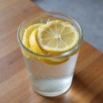 Close-up of a glass of water with lemon slices, representing hydration benefits